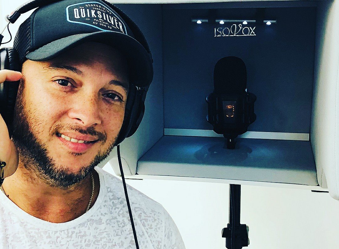 Man using the ISOVOX 2 vocal booth at home for recording new vocals
