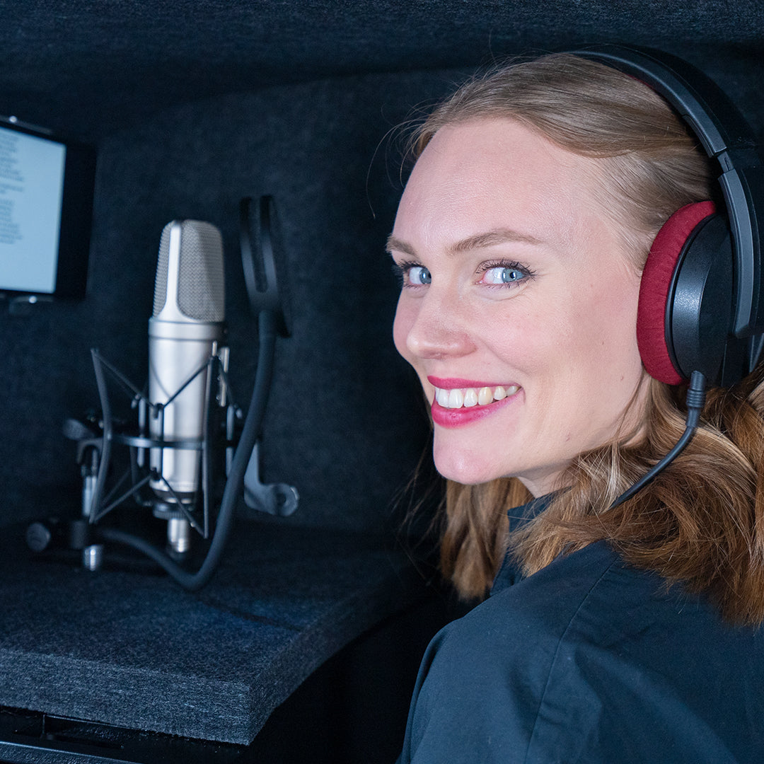 Woman standing inside the ISOVOX GO home recording booth