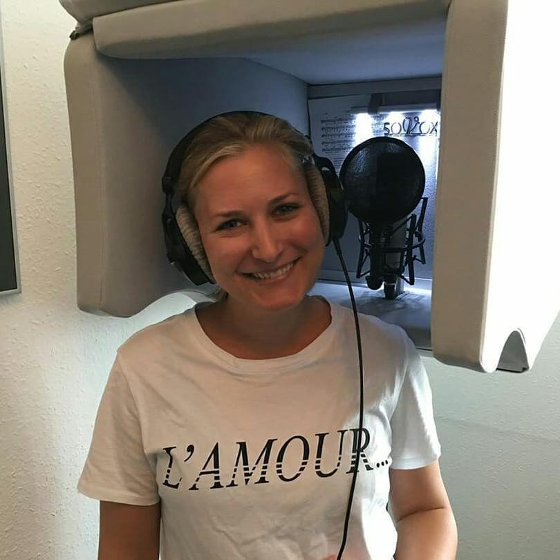 Woman standing inside the ISOVOX 2 white vocal booth 