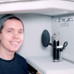 Famous Youtuber Roomie Standing inside the ISOVOX 2 White portable vocal booth recording vocals